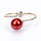 Anillo de Plata Bañada en Oro con Perla roja de río y Topacio Blanco