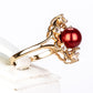 Anillo de Plata Bañada en Oro con Perla roja de río y Topacio Blanco